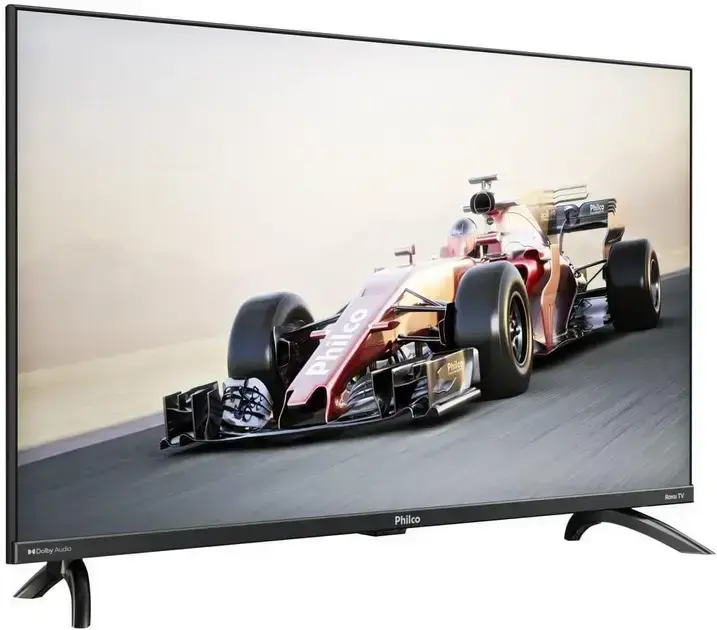 Televisão em um ambiente dinâmico, com fundo desfocado de pista de corrida e montanhas ao fundo.